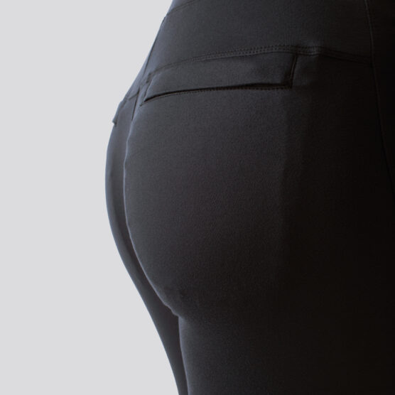 Rumpa til en dame i en sort joggebukse i teknisk stoff. Buksa har lommer bak.