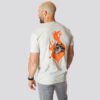 En mann med sandfarget t-skjorte som står med ryggen mot kameraet. På ryggen er det bilde av en brannkonstabels overkropp inne i en flamme.