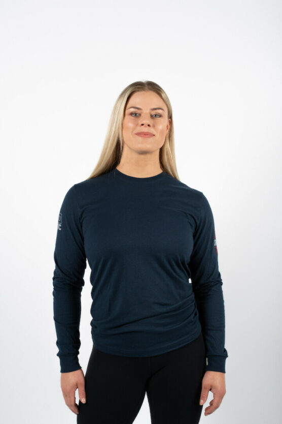 kvinne med blondt hår iført mørkblå genser med CF Lensmannslia-logo.