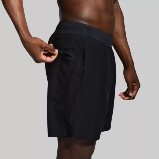 Mann med sort trenings-shorts med lommer og innertights. Innertightsen har lomme på én side.