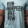 Mann iført turkis t-skjorte med sort skrift foran. Teksten sier "Run, Burpees, Bike, Row, Lift", der alt er gjennomstreket utenom "Lift".